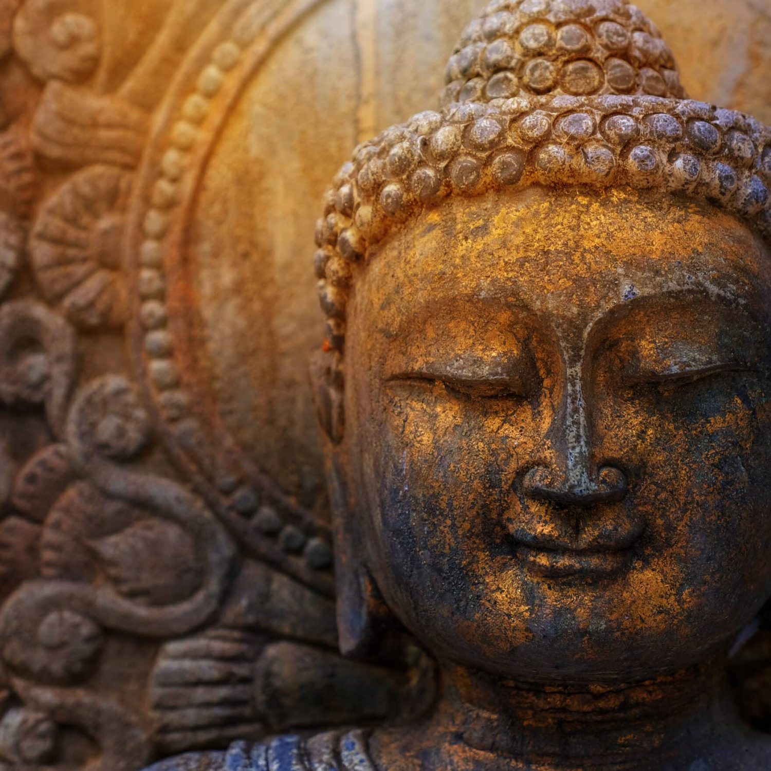 Rock Buddha statue with sunlight used for amulets of Buddhism religion. Buddhism is popular region in China Japan and south east Asia.copy space concept.